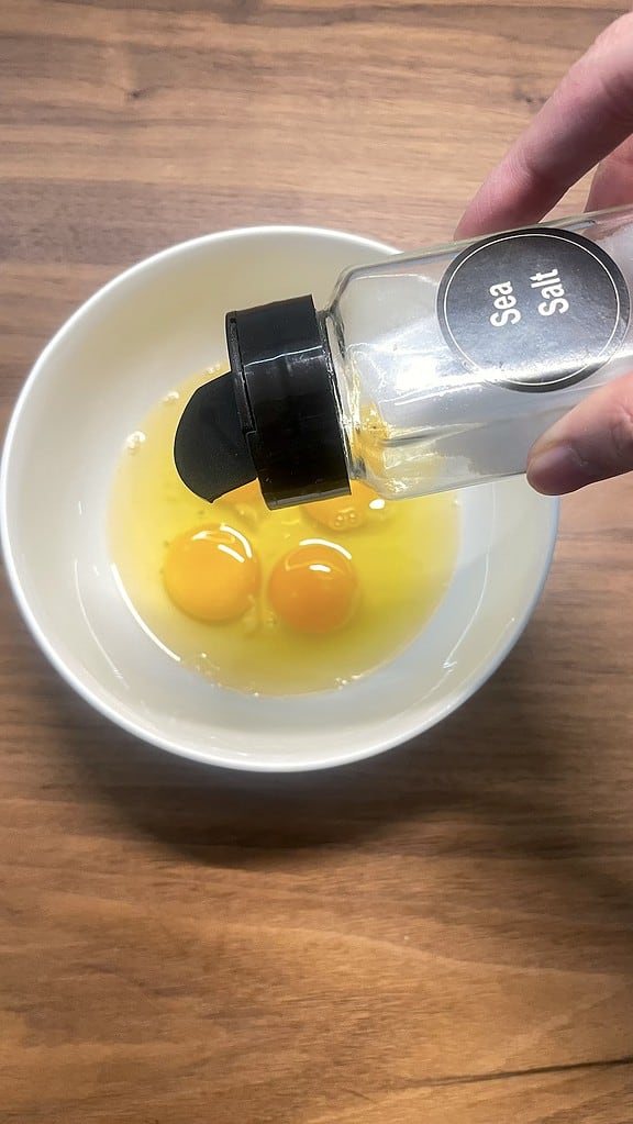 Season eggs with salt